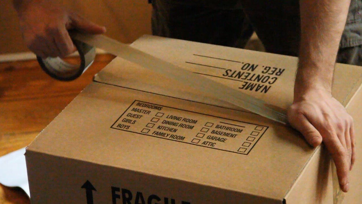 man-taping-packing-box